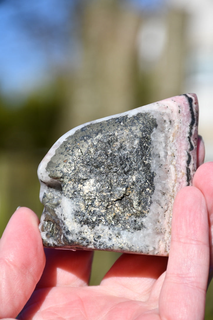 Rhodochrosite, pyrite and quartz skull - Manus carve