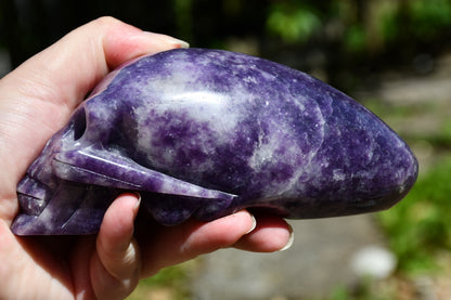 Elongated lepidolite traveller skull carve