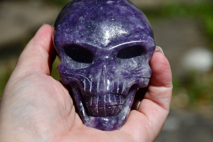 Elongated lepidolite traveller skull carve