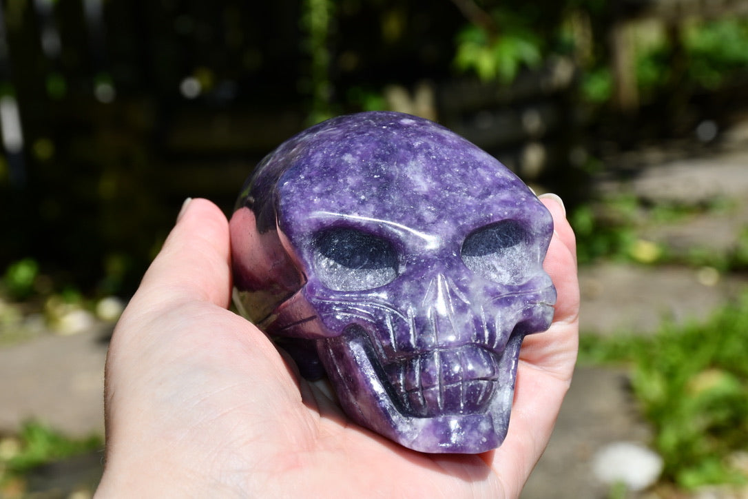 Elongated lepidolite traveller skull carve